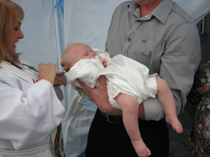 Rev. Marie-Louise Jones performing a baby blessing ceremony