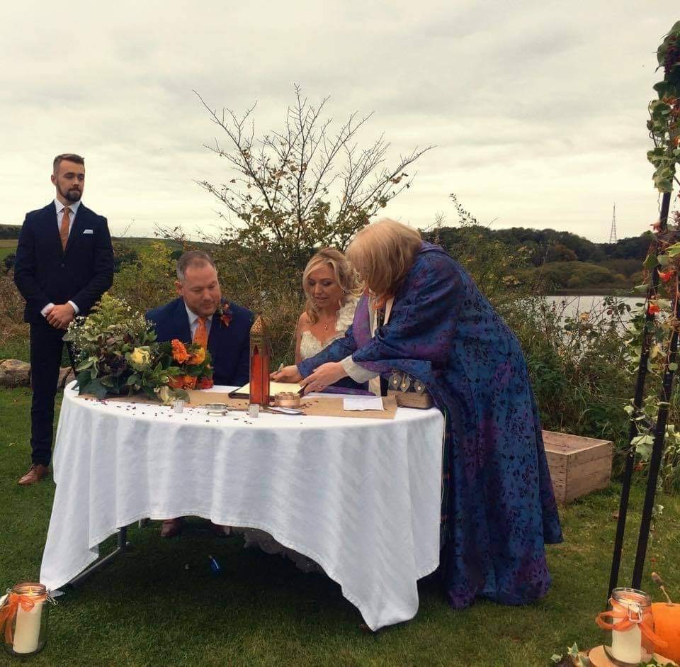Outdoor signing ceremony with Rev. Marie-Louise Jones